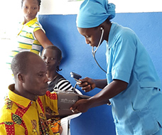 Female doctor taking blood pressure of male