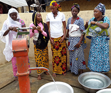 Group of woman gathered around a well