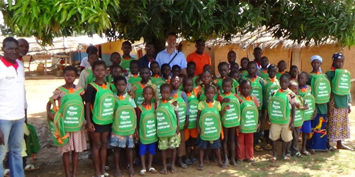 Group of school children in bright green shirts