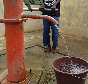 Water flowing out of well into bucket