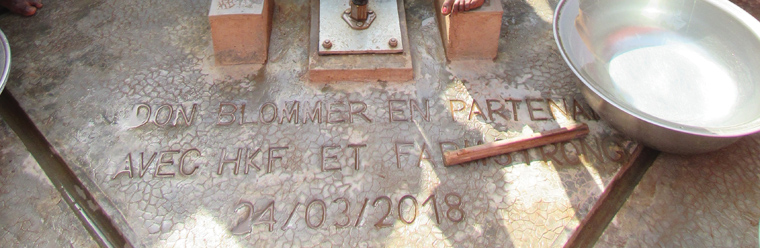 Photo of inscription in ground in front of water well